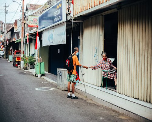 Person gazing out window for visual rest break during work day in Indonesian city