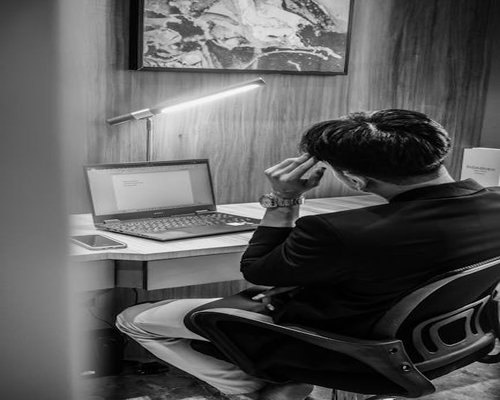 Young professional working on laptop in modern Jakarta office with good lighting
