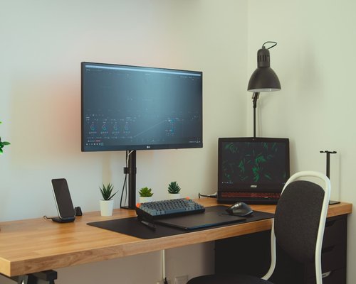Ergonomic workspace setup with proper monitor distance and good lighting in home office